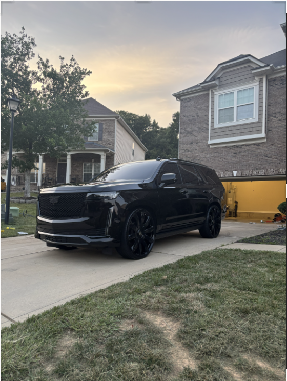 Blacked-out Cadillac Escalade with a mirror gloss finish after paint correction and ceramic coating by Mz. Detailing