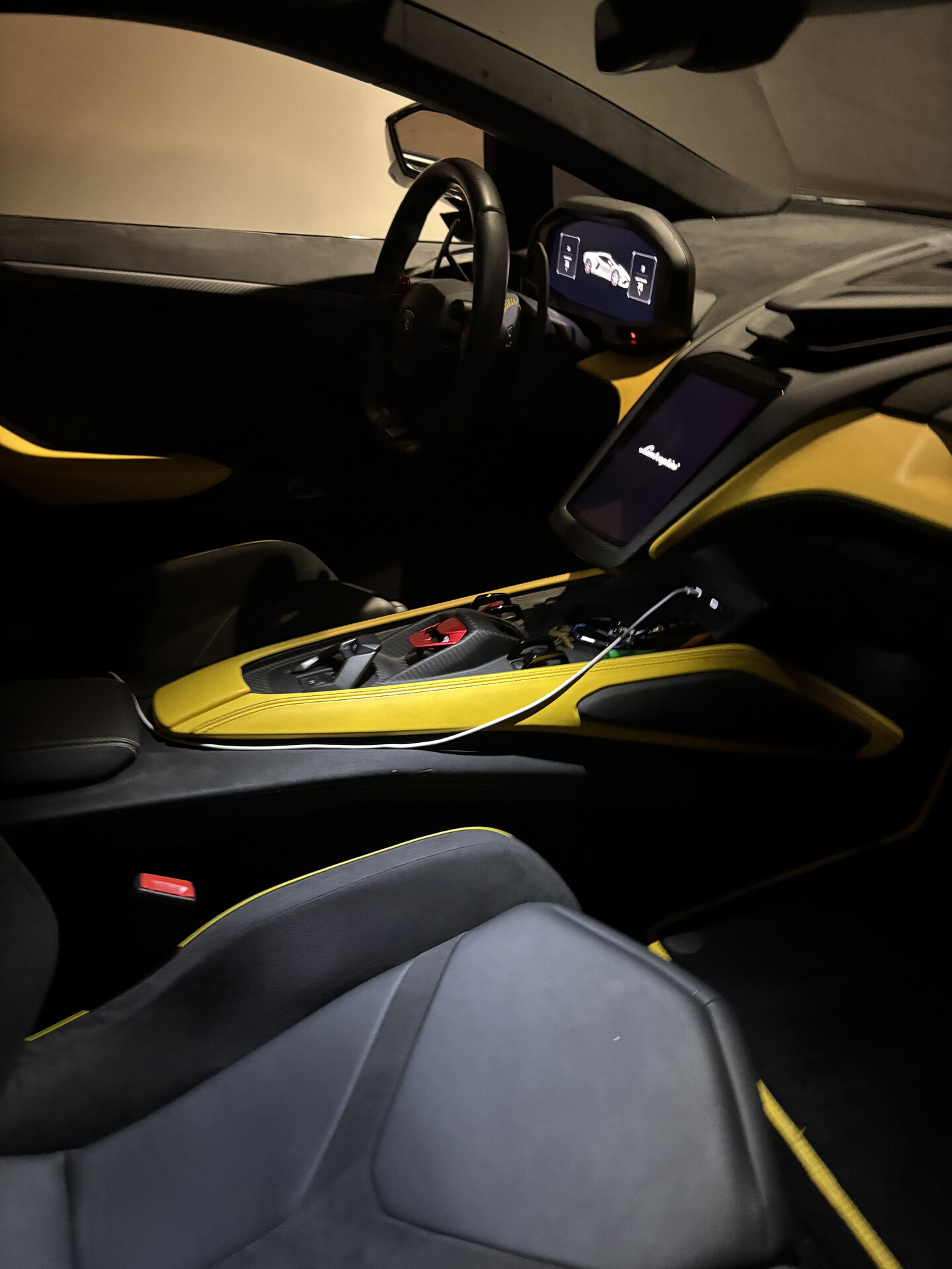 Lamborghini cabin with black and yellow leather after an interior detail by Mz. Detailing